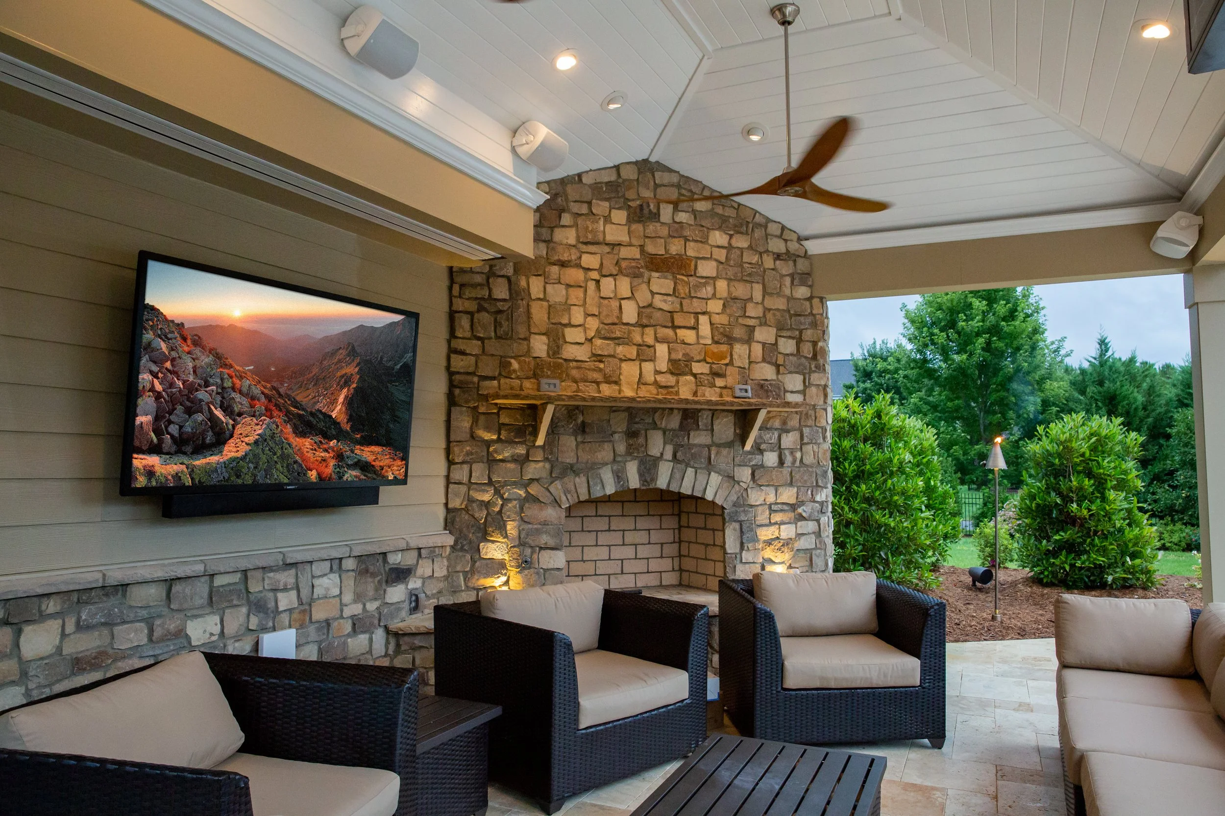 Outdoor entertainment space with integrated audio and shade