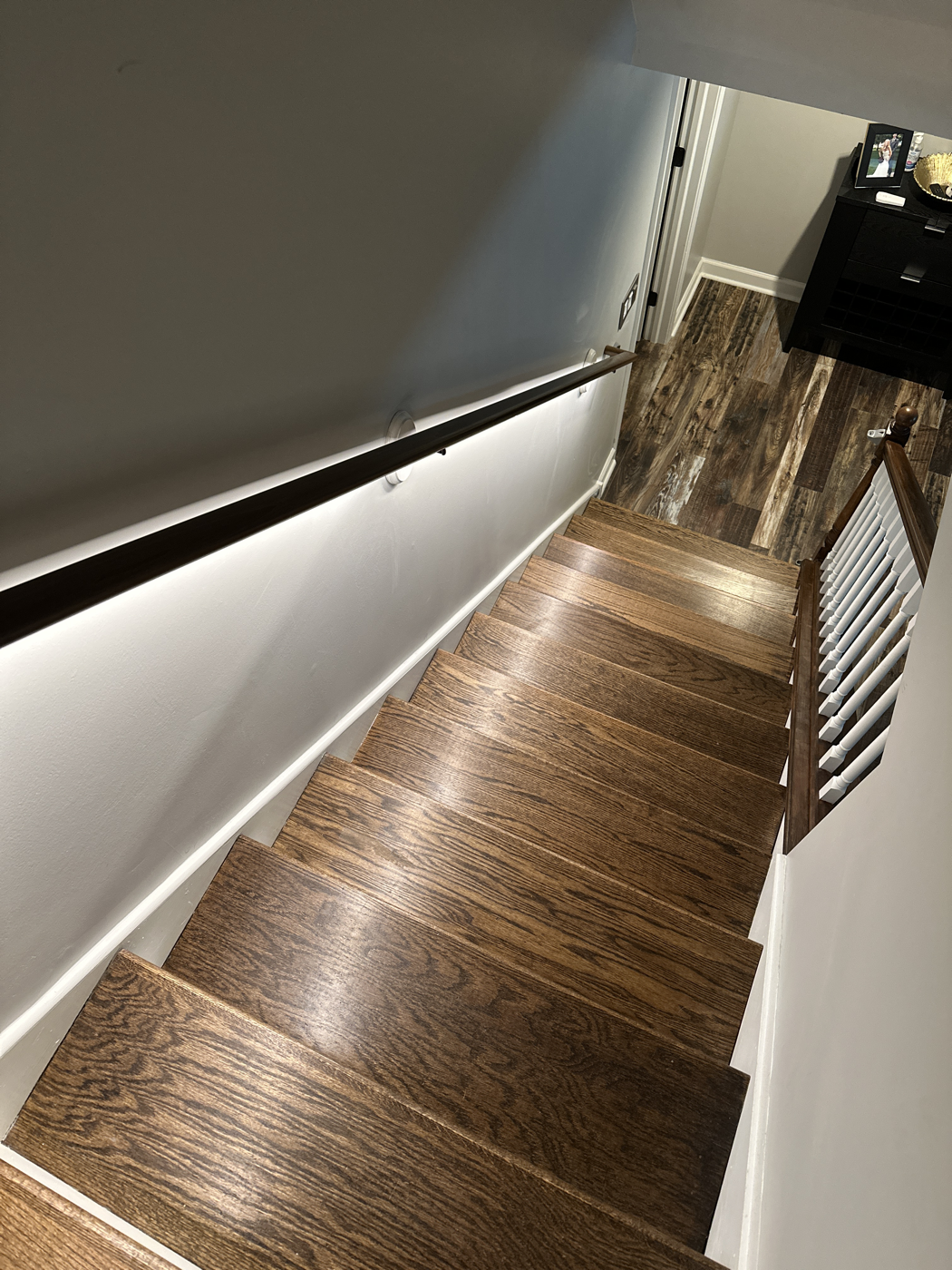 Custom LED handrail lighting on a Naperville staircase install
