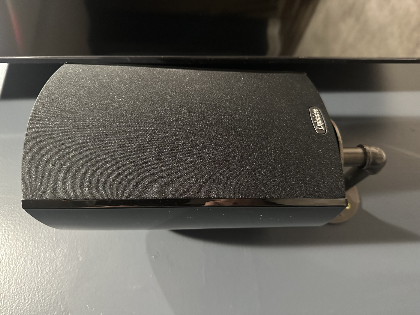 Close-up of a Definitive Technology in-wall speaker in a media room