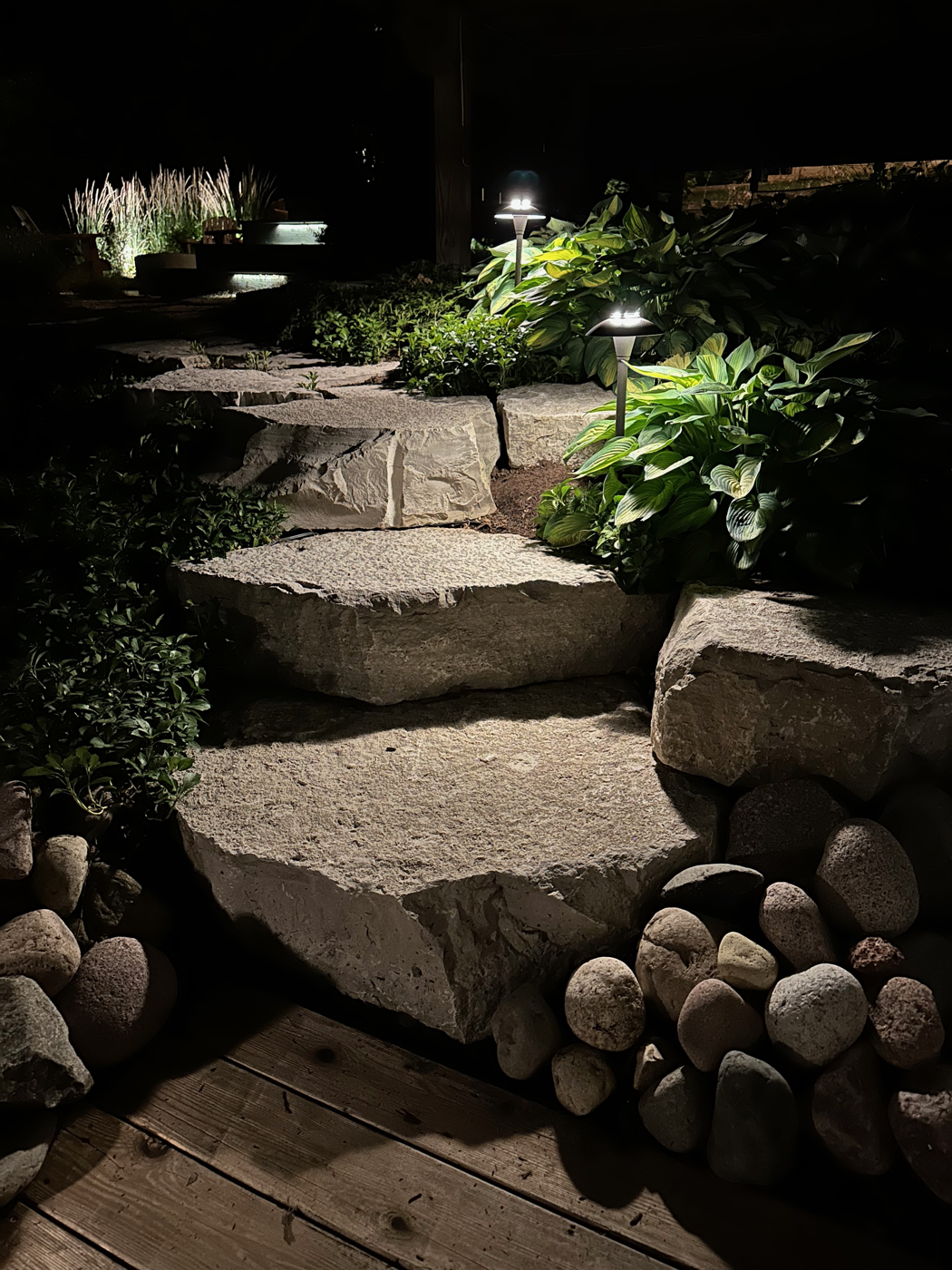 Outdoor stone steps lit with Lutron path lighting at night