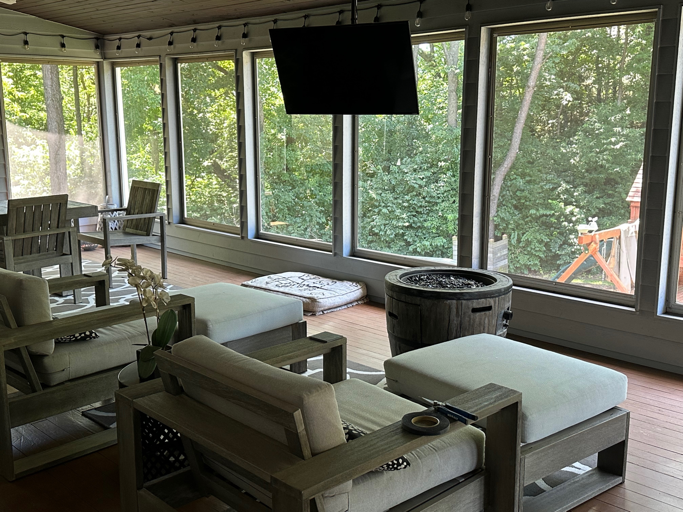 Three-season sunroom with mounted TV and integrated multi-room audio