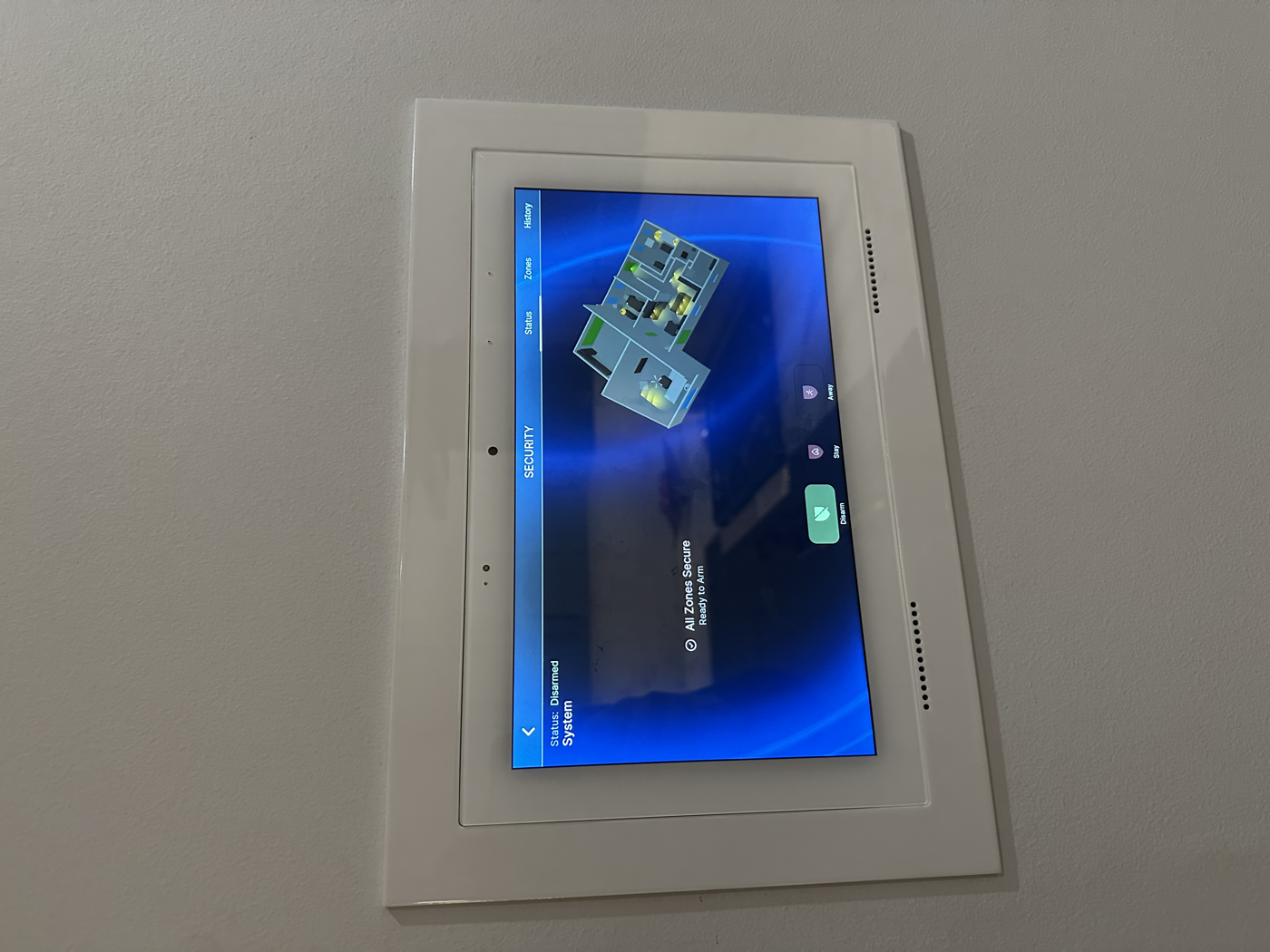 Wall-mounted touch panel showing unified home control and security in a Naperville home