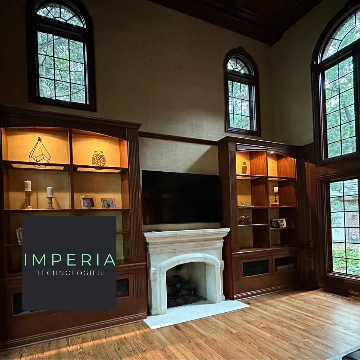 Built-in library shelving with integrated accent lighting around a fireplace